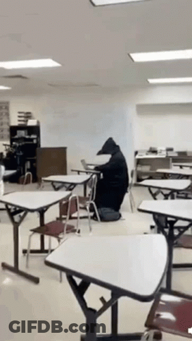 Bear Sitting At Table In Classroom GIF