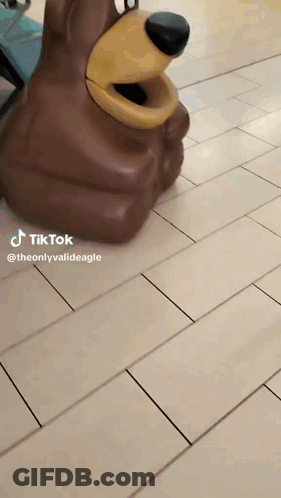 Bear Statue Sitting On Tiled Floor GIF