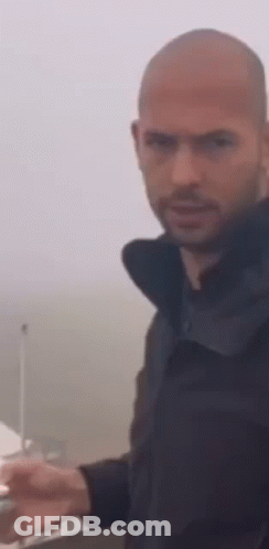 Bearded Bald Man Standing In Front Of Boat GIF