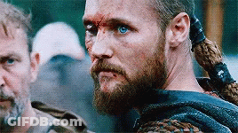 Bearded Blue-Eyed Man Next To Ponytailed Man GIF