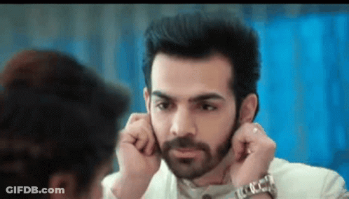 Bearded Man Adjusting Earring While Woman Looks On GIF