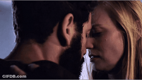Bearded Man And Blonde Woman Locking Eyes GIF