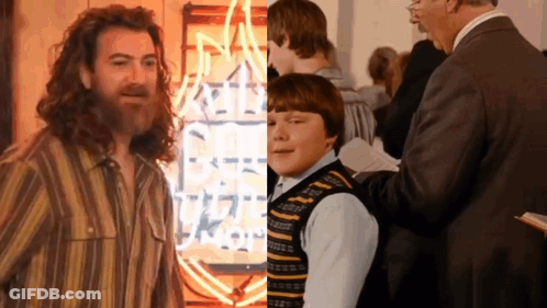 Bearded Man And Boy In Front Of Neon Rock Sign GIF
