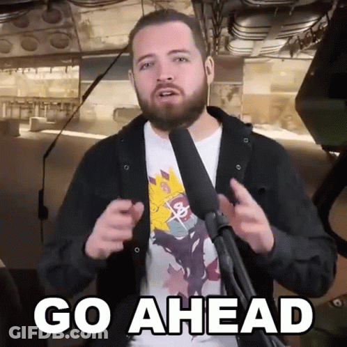 Bearded Man At Microphone Saying Go Ahead GIF