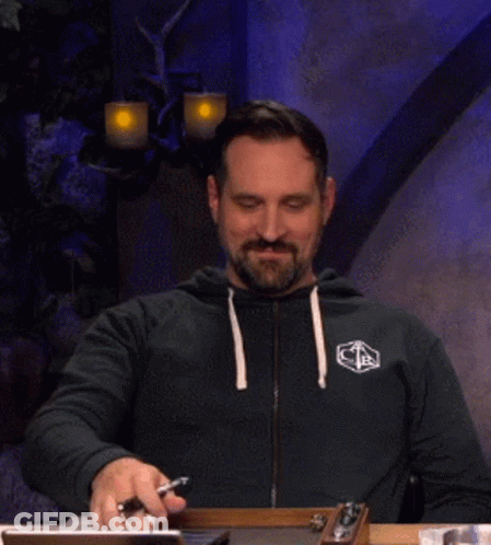 Bearded Man At Table With Phone And Pen GIF