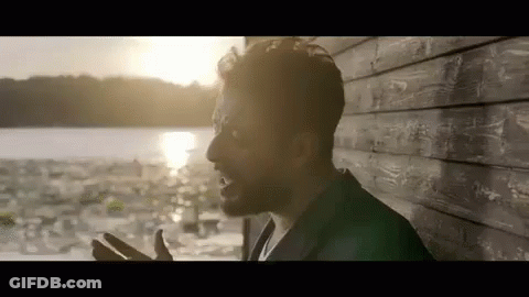 Bearded Man By Wooden Wall Near Water GIF