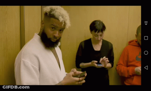 Bearded Man Checking Phone Woman Watching GIF