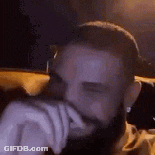 Bearded Man Covering Mouth On Couch GIF