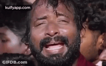 Bearded Man Crying Eyes Closed In Front Of Crowd GIF