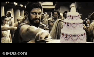 Bearded Man Cutting Cake In Front Of Crowd GIF
