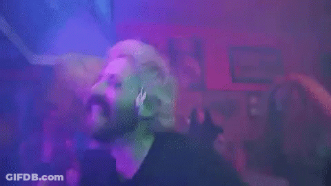 Bearded Man Dancing In Club In Front Of Purple Lights GIF