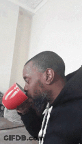 Bearded Man Drinking From Red Coffee Mug GIF