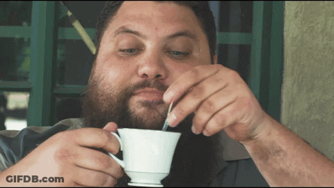 Bearded Man Drinking From White Cup With Spoon GIF