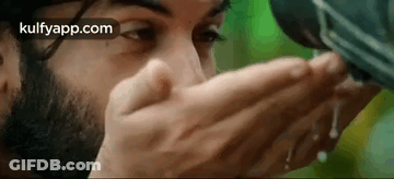 Bearded Man Drinking Water From Container GIF
