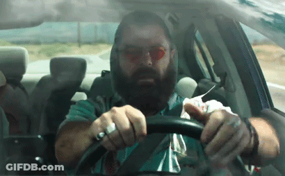 Bearded Man Driving Car With Napkin On Face GIF
