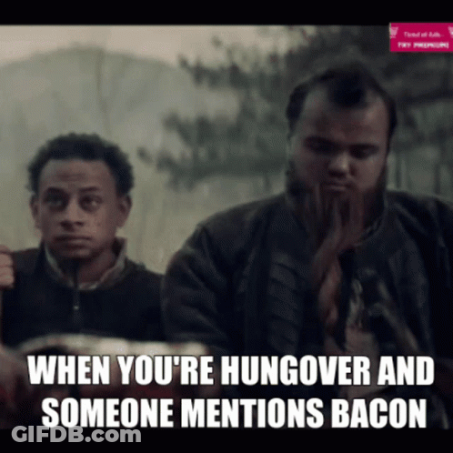 Bearded Man Eating Bacon Watched By Man GIF