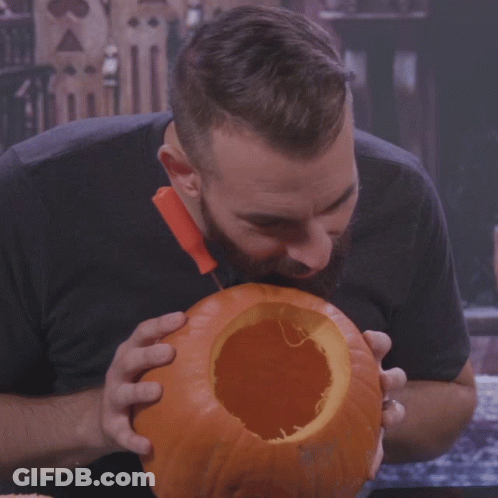 Bearded Man Eating Pumpkin With Knife GIF