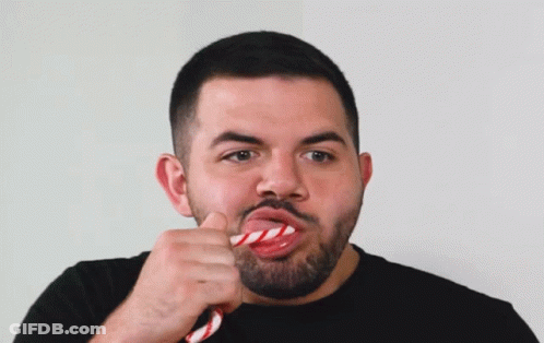 Bearded Man Eating Red And White Candy Cane GIF