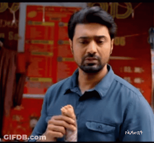 Bearded Man Eating Sandwich In Front Of Store GIF