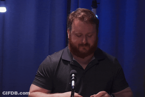 Bearded Man Gesturing At Microphone GIF