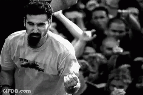 Bearded Man Giving Middle Finger At Concert GIF