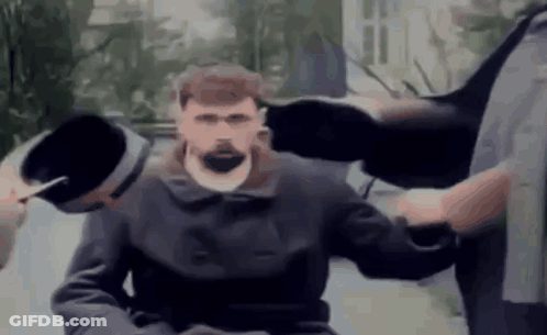 Bearded Man Held By Two Men In Wheelchair GIF