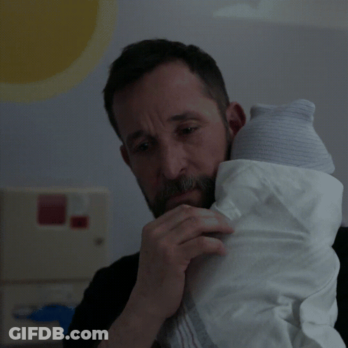 Bearded Man Holding Baby In White Blanket GIF