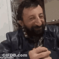 Bearded Man Holding Beer At Table GIF
