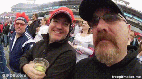 Bearded Man Holding Beer In Front Of Crowd GIF