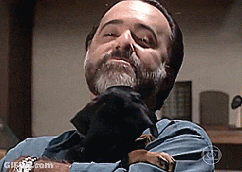 Bearded Man Holding Black Dog GIF