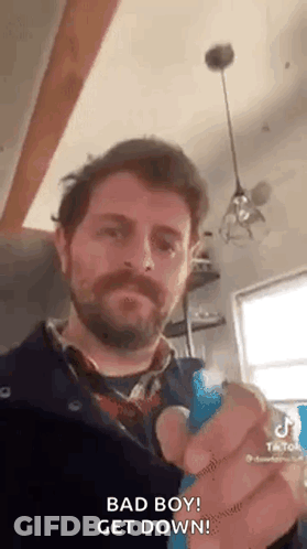 Bearded Man Holding Blue Object Saying Bad Boy GIF