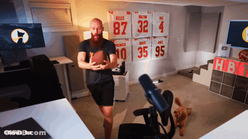 Bearded Man Holding Football In Front Of Jersey Wall 87 32 4 35 95 GIF