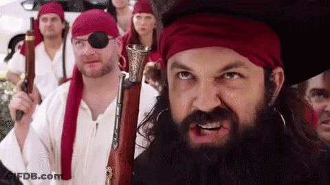 Bearded Man Holding Gun In Front Of Pirates GIF
