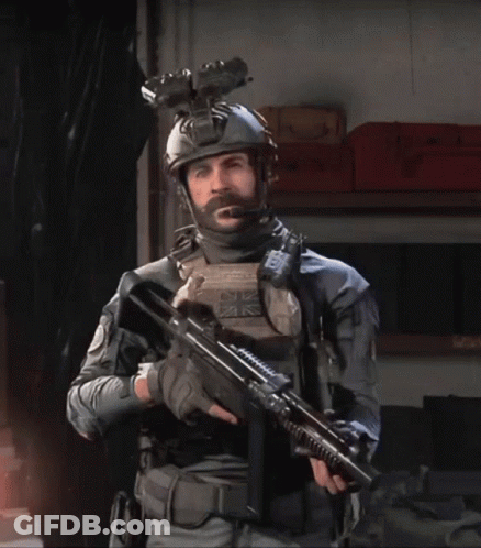 Bearded Man Holding Gun With UK Helmet GIF