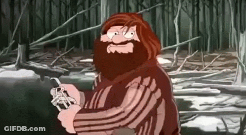 Bearded Man Holding Knife In Forest GIF