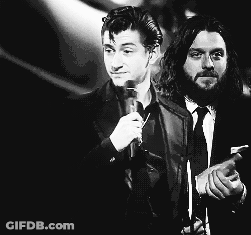 Bearded Man Holding Microphone Next To Man In Suit And Tie GIF