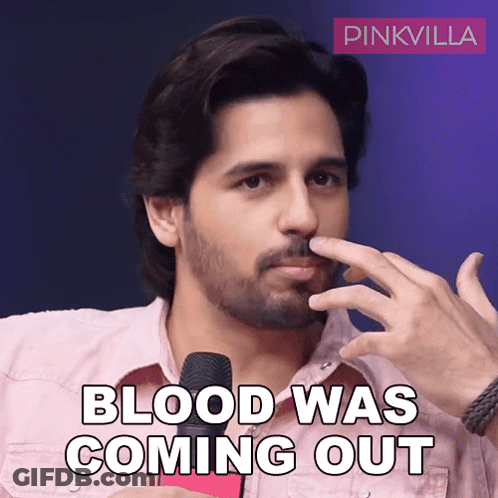 Bearded Man Holding Nose In Front Of Pinkvilla Logo GIF