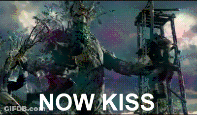 Bearded Man Holding Statue Saying Now Kiss GIF