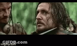 Bearded Man Holding Sword In Mouth With Onlooker GIF