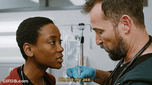 Bearded Man Holding Syringe Talking To Woman In Hospital GIF
