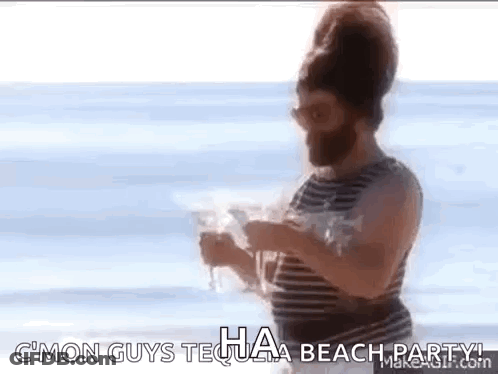 Bearded Man Holding Wine Glass On Beach GIF