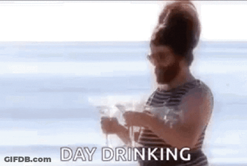Bearded Man Holding Wine On Beach GIF