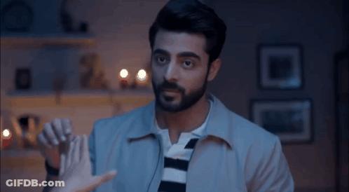 Bearded Man Holding Woman's Hand In Living Room GIF