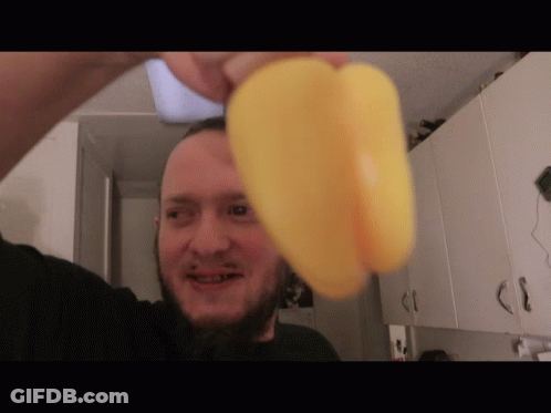 Bearded Man Holding Yellow Pepper GIF
