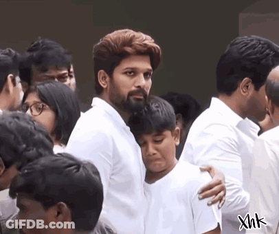 Bearded Man Hugging Boy In Crowd GIF