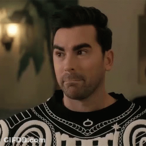 Bearded Man In Black And White Sweater Making Face GIF
