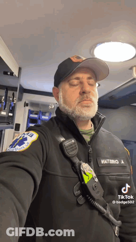 Bearded Man In Black Jacket And Hat With EMT Patch GIF