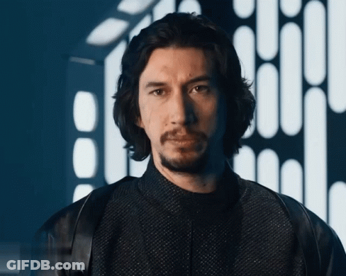 Bearded Man In Black Jacket Looking At Camera GIF