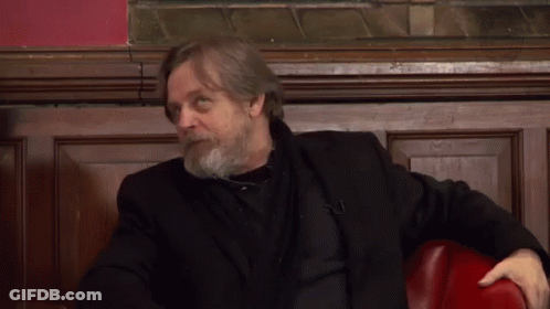Bearded Man In Black Jacket Sitting On Red Chair GIF