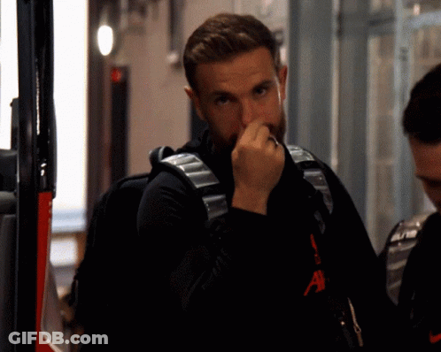 Bearded Man In Black Nike Shirt Holding Nose GIF